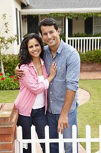 Hispanic couple outside home