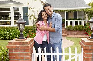 Hispanic couple outside home