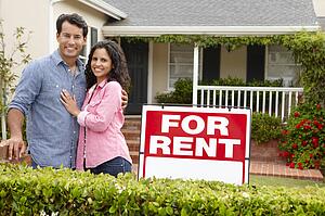Hispanic couple outside home for rent