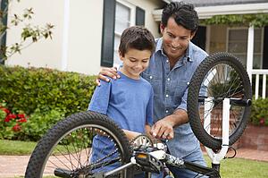 Father and son fixing bike
