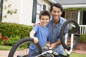 Father and son fixing bike