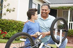 boy and grandfather fixing bike
