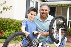 boy and grandfather fixing bike