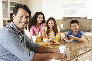 Hispanic family eating breakfast