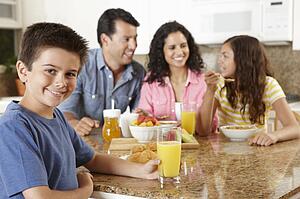 Hispanic family eating breakfast