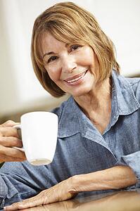Mid age woman drinking coffee