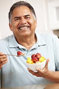 Senior man eating fruit