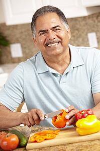 Senior man chopping vegetables