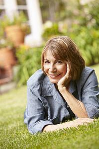 Mid age woman relaxing in garden