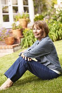 Mid age woman relaxing in garden