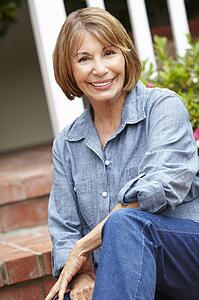 Mid age woman relaxing in garden