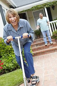 Senior couple playing with children's scooter