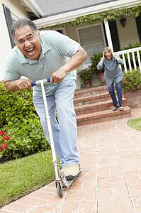 Senior couple playing with children's scooter