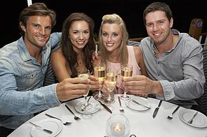 Two young couples in restaurant