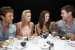 Two young couples in restaurant