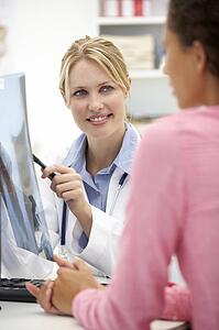 Young doctor with female patient