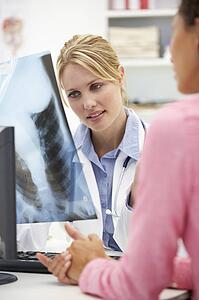 Young doctor with female patient
