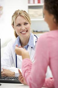 Young doctor with female patient