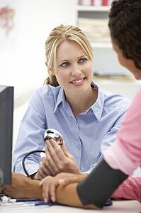 Young doctor with female patient