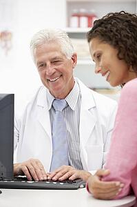 Senior doctor with female patient