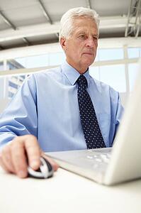 Senior businessman using laptop
