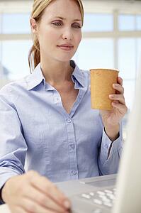 Businesswoman with laptop and coffee