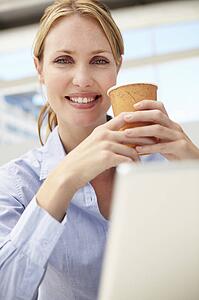 Businesswoman with laptop and coffee