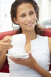 Young woman relaxing with cup of tea