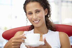 Young woman relaxing with cup of tea