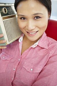 Young woman listening to radio
