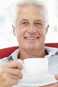 Senior man relaxing with cup of tea