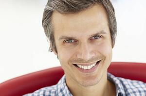 Man sitting in red chair