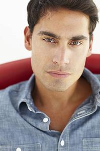 Young man sitting in red chair