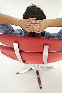 Young man relaxing in red chair