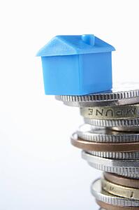 Small model house and coins