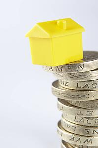 Small model house and coins