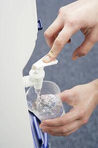 Woman filling cup at water cooler