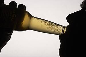 Silhouette man drinking beer