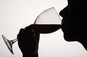 Silhouette man drinking red wine
