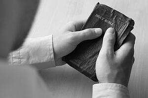 Young man holding bible