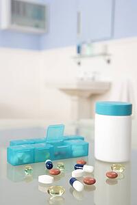 Pills and organiser in bathroom