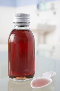 Cough medicine on bathroom shelf