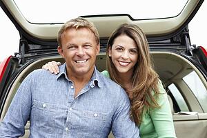 Couple outdoors with car