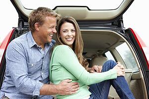 Couple outdoors with car