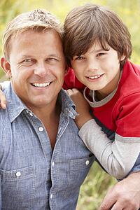 Portrait father and son outdoors