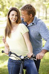 Couple with bike in park