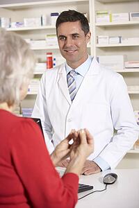 American pharmacist with senior woman in pharmacy
