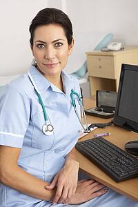 British nurse sitting at desk at work