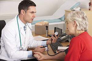 American doctor taking senior woman's blood pressure