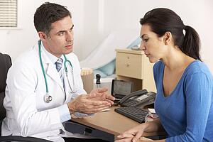 American doctor talking to woman in surgery